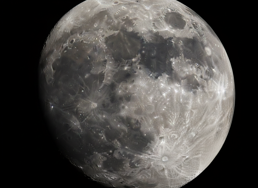 Detailed, naturalistic image of the Moon's surface showing numerous craters of varying sizes, some dark maria (flat plains), and brighter highlands, viewed from space, no text on image